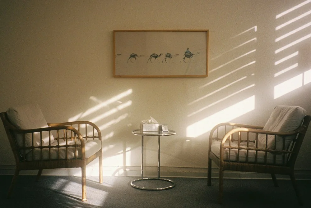 Two chairs and a table in afternoon sunlight